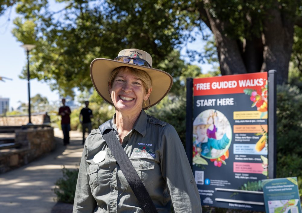 A smiling Kings Park Guide standing by the Free Guided Walks starting point.