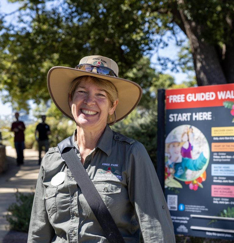 A smiling Kings Park Guide standing by the Free Guided Walks starting point.